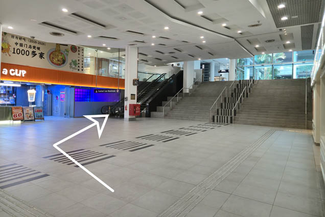 Turn right and go up the escalator