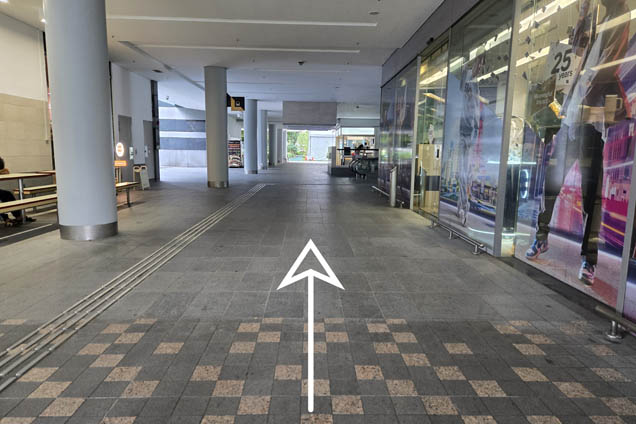 Follow the arrow and walk straight past SMU Shop