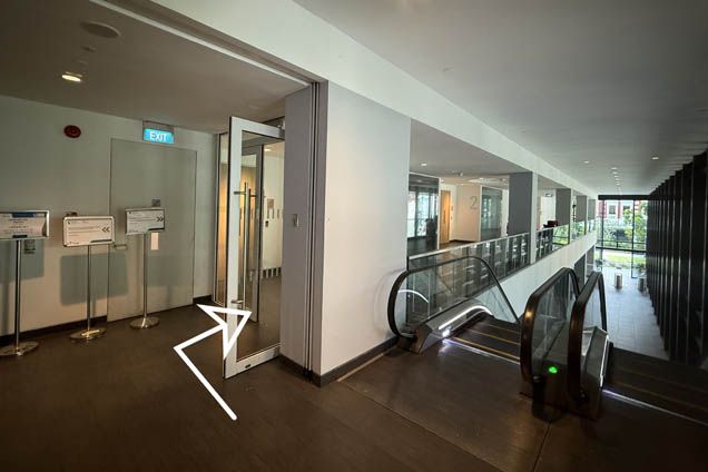 1.2. At the top of the escalator, turn right and enter the door to Seminar Room 2-01 to 2-03