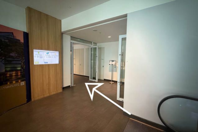 4.2. At the top of the escalator, enter the door beside the TV screen