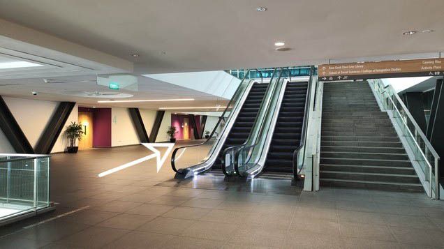 3.3. Keep left and walk past the escalator