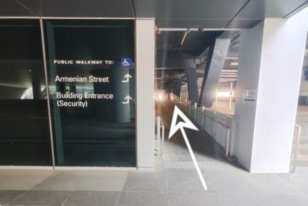 5. You will see the directions to Building Entrance (Security). Walk up the ramp, continue straight and turn left at the end